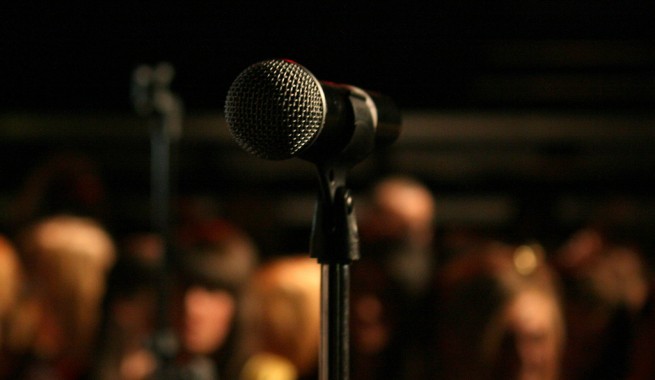 improv mic with audience in background